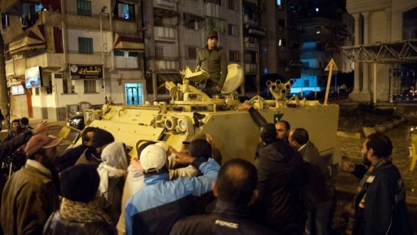 Egyptian protestors shout at a soldier standing in an armored personnel carrier as they demonstrate in the streets of the canal city of Port Said. (AFP PHOTO / STR)