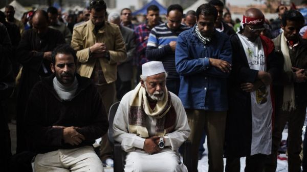 Egyptian anti-government protestors perform Friday prayers ahead of a demonstration on Friday. (AFP PHOTO/GIANLUIGI GUERCIA)