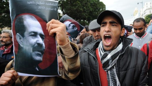 A Tunisian protester holds a placard featuring killed opposition leader Chokri Belaid during a demonstration on Saturday. (AFP PHOTO / FETHI BELAID)