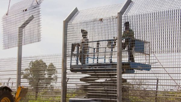 Laborers work at the construction site of a border fence along Israel's border with Syria in the Golan Heights. (AFP PHOTO/JACK GUEZ)