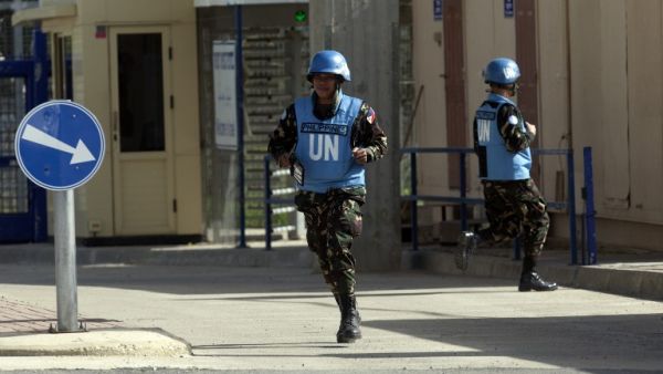 Filipino UN peacekeepers cross the Quneitra checkpoint between Israel and Syria in the Golan Heights on Saturday. (AFP PHOTO/AHMAD GHARABLI)