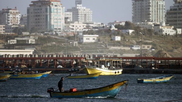A Palestinian fisherman rides a boat near the port of Gaza City on March 22, 2013. Israel cut the distance from the shore that Gaza fishermen are allowed to sail from six to three miles and shut the Kerem Shalom goods crossing from Israel into the Gaza Strip in response to a rocket attack against southern Israel. (AFP PHOTO/MOHAMMED ABED)
