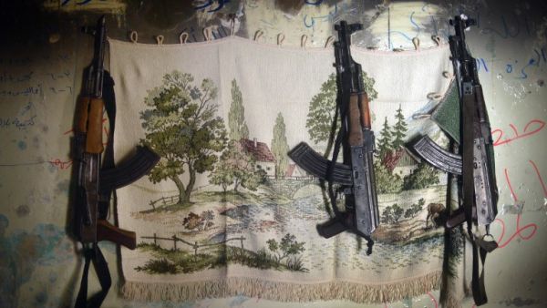 AK-47 machine guns hang in a shelter for Syrian rebels in the Salaheddine district of the northern Syrian city of Aleppo. (AFP PHOTO / DIMITAR DILKOFF)