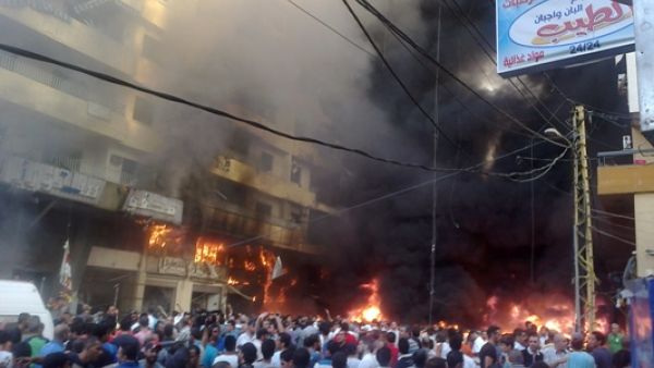 Lebanese people gather at the site of a car bomb between the Bir el-Abed and Roueiss neighbourhoods, in the southern suburb of Beirut on August 15, 2013. A powerful car bomb killed at least three people and wounded several others in a Beirut stronghold of Lebanon's Shiite movement Hezbollah, national news agency NNA reported. (AFP)