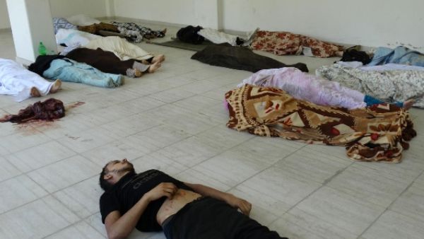Bodies are laid out on the ground at a makeshift morgue as Syrian rebels claim they were killed in a toxic gas attack by pro-government forces in eastern Ghouta, on the outskirts of Damascus on August 21, 2013(AFP PHOTO / HO / SHAAM NEWS NETWORK)