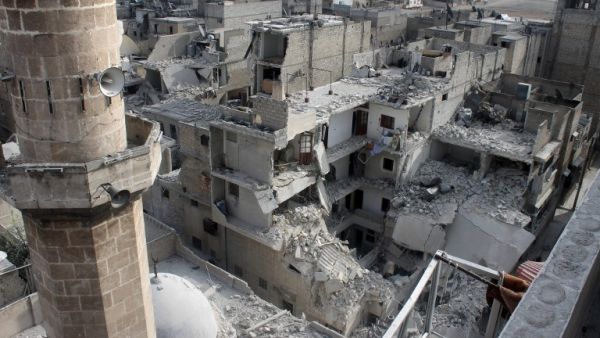A picture taken on January 19, 2014 in the northern Syrian city of Aleppo shows buildings that fell following Government warplanes raids .[AFP]