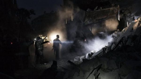 Syrians look for survivors amidst the rubble of a building targeted by a missile in the al-Mashhad neighbourhood of Aleppo. (AFP PHOTO / STR)