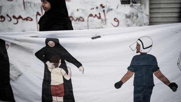 A Bahraini protester holds a banner during an anti-regime rally in solidarity with jailed political activists and against the upcoming Bahrain Formula One Grand Prix. (TOPSHOTS/AFP PHOTO/MOHAMMED AL-SHAIKH)