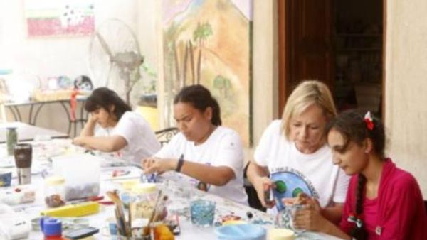 Artists at work: Ange (second from left) and fellow artists engrossed in their creations
