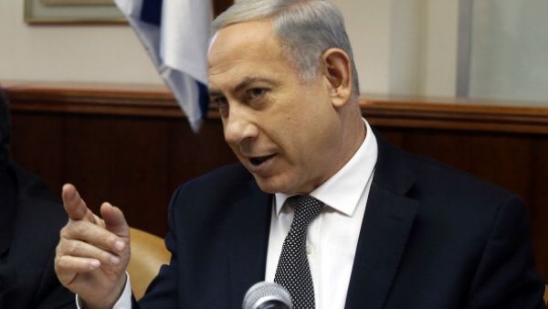 Israeli Prime Minister Benjamin Netanyahu gestures as he opens the weekly cabinet meeting at his Jerusalem office on December 22, 2013. [AFP]