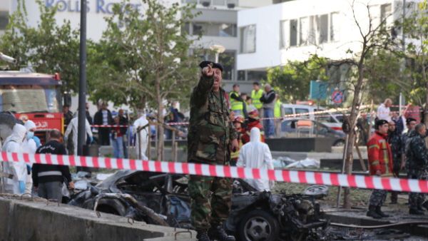 Lebanese security forces inspect the scene of a huge car bomb explosion that rocked central Beirut on December 27, 2013, killing Mohamed Chatah. [AFP]