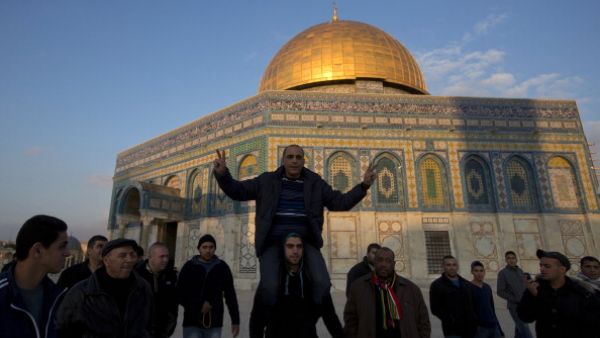 Recently released Palestinian prisoner Ahmad Khalaf  is carried by friends in front of the Dome of the Rock at the Al-Aqsa mosque compound in the Old City of Jerusalem on December 31, 2013. [Getty Images]