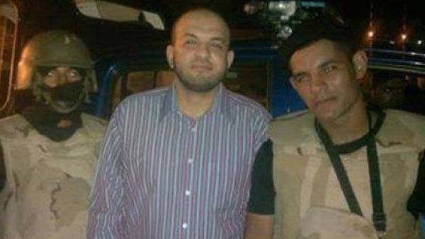 Ahmed Arif is seen smiling with the police that arrested him. (Egyptian police Facebook) Ahmed Arif is seen smiling with the police that arrested him. (Egyptian police Facebook)