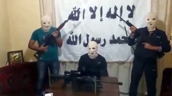 A screengrab taken from a video released on You Tube on August 15, 2013 allegedly shows three armed and masked members of a previously unknown Syrian rebel group that claimed responsibility for the blast in the Lebanese capital Beirut. (AFP/YouTube)