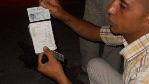 Alaa shows us his tainted ID card