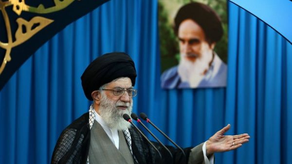 Iran's supreme leader, Ayatollah Ali Khamenei, delivers the Eid al-Fitr prayer sermon at Tehran University in the Iranian capital on August 9, 2013. Portrait in the background shows the late founder of the Islamic republic Ayatollah Ruhollah Khomeini. (AFP)