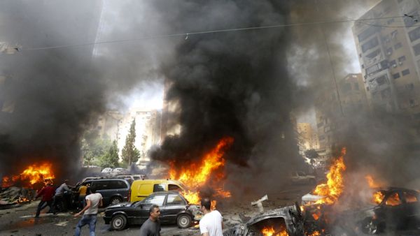 Civilians gather at the of an explosion in Beirut's southern suburb neighbourhood of Bir al-Abed on July 9, 2013. (Source: AFP/STR)