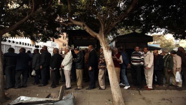 Egyptian men partake in the referendum, at a polling station in Cairo  to cast their votes on a new constitution, December 15
