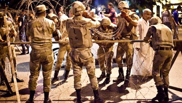 Egyptian army soldiers take out barbed wire that was surrounding the Supreme Constitutional Court in Cairo ahead of planned demonstrations on August 18, 2013. (AFP)
