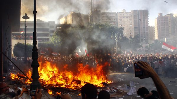 Opponents of Egyptian President Mohamed Morsi burn the content of a Freedom and Justice Party office in the coastal city of Alexandria on June 28, 2013. One person was killed and more than 70 injured in Egypt's second city of Alexandria on Friday as clashes raged between supporters and opponents of Islamist President Mohamed Morsi, state media reported. (Source: AFP)