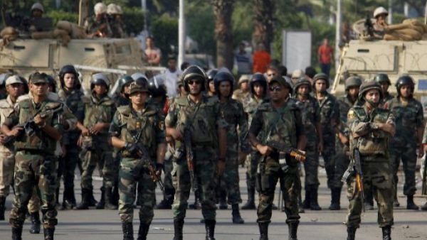 Egyptian army's soldiers stand guard in Cairo's eastern Nasr City district on October 11, 2013, as supporters of Egyptian ousted president Mohamed Morsi demonstrate against the military. (AFP)