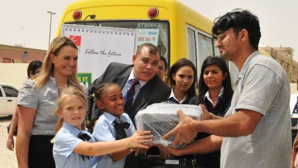 Eros Group and GEMS distributing electronic items to students