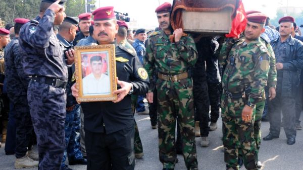 Military officers carry the coffin of a comrade during his funeral in the city of Nasiriyah, on December 31, 2013, after he was killed in fighting in the western Anbar province. (AFP)
 Military officers carry the coffin of a comrade during his funeral in the city of Nasiriyah, on December 31, 2013, after he was killed in fighting in the western Anbar province. (AFP)