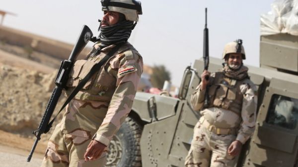Iraqi soldiers stand along a road close to their vehicle in the area of Ein Tamer which leads west out of the central Iraqi Shiite Muslim shrine city of Karbala towards the mainly Sunni Muslim city of Fallujah. The U.S. has stepped up military aid to the restive country. (AFP)

