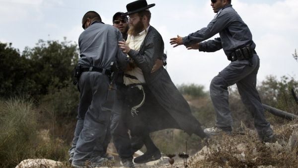  An Ultra-Orthodox Jewish man is arrested by Israeli policemen in Ramat Beit Shemesh West of Jerusalem on August 12. (AFP)