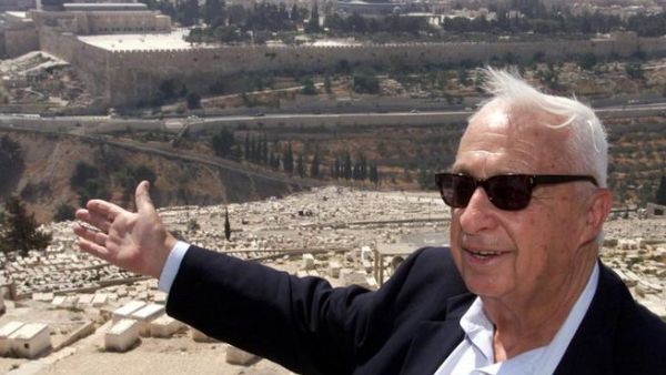 Opposition leader Ariel Sharon of the right-wing Likud gestures towards Jerusalem's Old City 24 July 2000 on the Mount of Olives during a rally to protest any land concessions in Jerusalem to the Palestinians. (AFP/File)