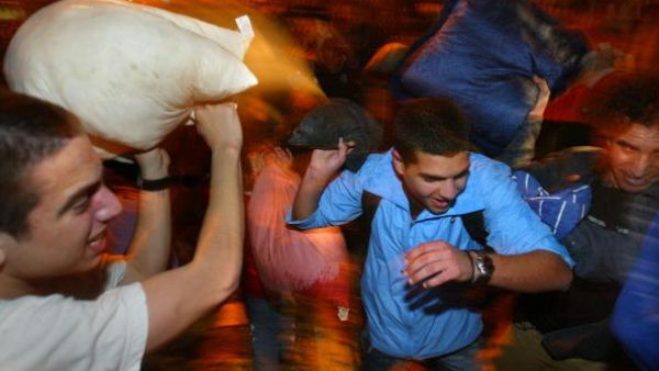 Men fighting with pillows in Israel