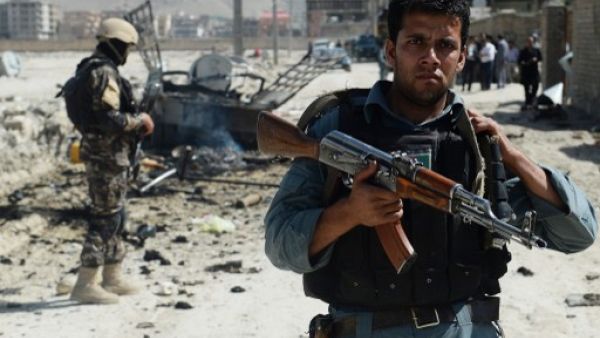 Afghan security forces stand guard at the site of a suicide attack near Kabul military airport in Kabul on Monday. AFP photo