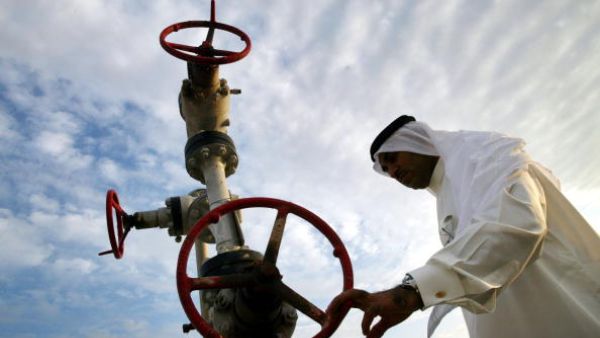 A man inspects a natural gas pipe in Bahrain