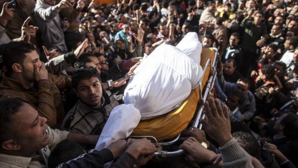 Egyptians carry the body of one of the thirteen people killed in a car bomb attack earlier in the day, during his funeral in the Egyptian city of Mansura, North of Cairo, on December 24, 2013. (AFP)
