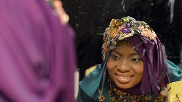 Obabiyi Aishah Ajibola, a 21-year-old contestant from Lagos, looks in the mirror shortly before winning the Miss Muslim World competition. (AFP)