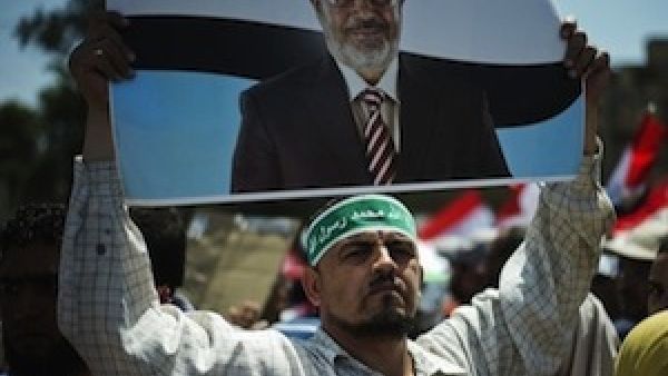 Egyptian Islamist groups led by the ruling Muslim Brotherhood take part in a demonstration to mark the upcoming one year anniversary since President Mohamed Morsi (portrait) was elected, on June 21 in Cairo. (AFP)