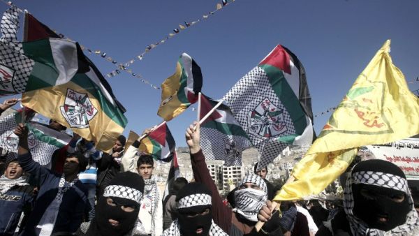 Palestinian supporters of the Palestinian leader Mahmud Abbas’ Fatah party wave flags during a rally marking the 49th anniversary of the movement on January 2, 2014 in the West Bank city of Nablus. (AFP) Palestinian supporters of the Palestinian leader Mahmud Abbas’ Fatah party wave flags during a rally marking the 49th anniversary of the movement on January 2, 2014 in the West Bank city of Nablus. (AFP)