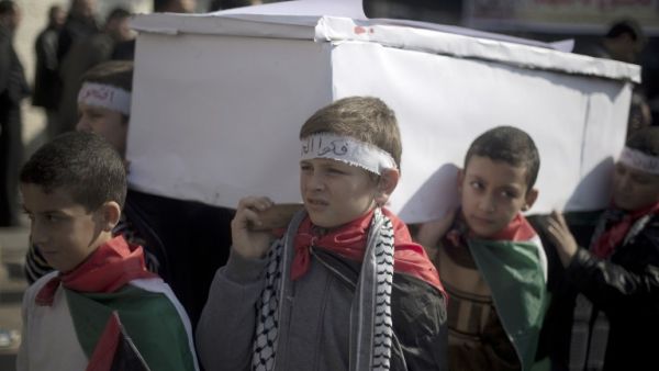 A lack of food and medical supplies is also causing death in Yarmouk. Here, Palestinian children in Gaza stage a fake funeral in solidarity with their brothers in the besieged Damascus camp. (AFP/File)