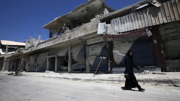 A Syrian resident walks in a devastated street on August 1, 2013 in a street of the city of Qusair, in Syria's central Homs province. (AFP)