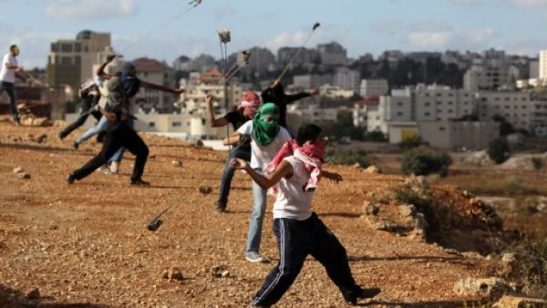 Palestinian protesters hurl rocks at Israeli soldiers during clashes in Betunia near the West Bank city of Ramallah on October 4, 2013. The Palestinian and Israeli delegations locked horns at the IPU meeting in Geneva on Wednesday. (AFP)
Palestinian protesters hurl rocks at Israeli soldiers during clashes in Betunia near the West Bank city of Ramallah on October 4, 2013. The Palestinian and Israeli delegations locked horns at the IPU meeting in Geneva on Wednesday. (AFP)