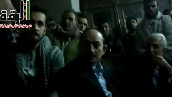 Syrian rebels appear in this YouTube video gathered around two men, one of them identified as Raqqa governor Hussein Jalali. (Al Arabiya) Syrian rebels appear in this YouTube video gathered around two men, one of them identified as Raqqa governor Hussein Jalali. (Al Arabiya)