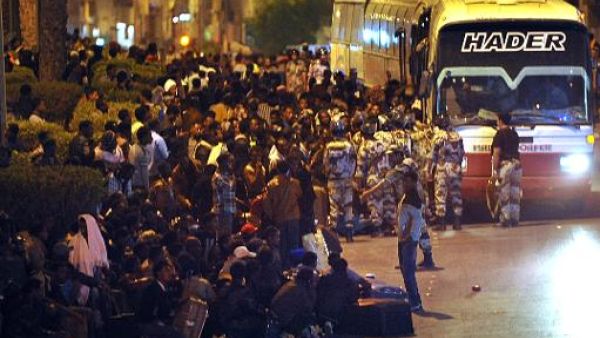 The Saudi Arabian government has deported more than 126,000 illegal workers in the one month since the authorities cracked down on migrants in the Kingdom. Here, Illegal migrants wait to be transferred by police buses to a deportation centre in Riyadh, on November 13, 2013 (AFP)
