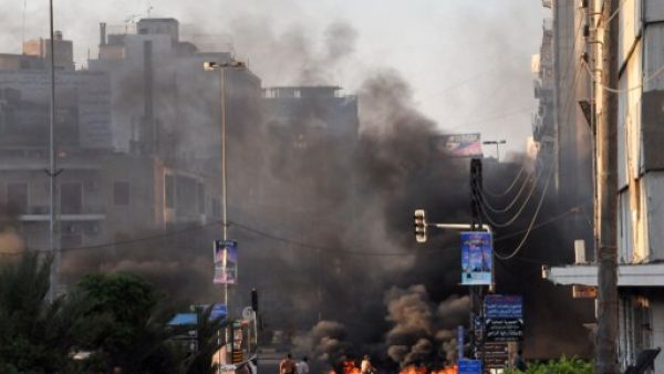 Black smoke acsends from burning tires laid across a street in the northern city of Tripoli on Sunday. (AFP)