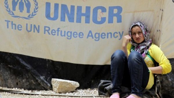 A Syrian refugee leans against a tent in the northern Jordanian Zaatari refugee camp. AFP 
