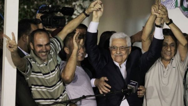 Palestinian president Mahmoud Abbas greeted the first group of released prisoners under the peace talks deal in August (File Archive/AFP)