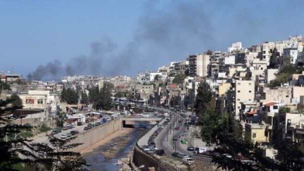 Smoke rises from above Tripoli's predominantly Sunni Bab Al-Tabbaneh neighborhood following days of fatal clashes with the Alawite neighborhood of Jabal Mohsen (Joseph Eid/AFP)