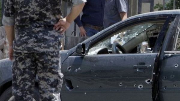 ارشيف/ رجل امن عراقي يقف امام سيارة تعرضت لهجوم بالرصاص