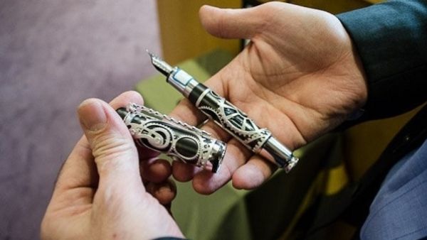The president is using a Mont Blanc pen, which commemorates the life of Charlie Chaplin, to fund homes for the country’s war veterans and single mothers. (Image courtesy: Iran State News Agency)