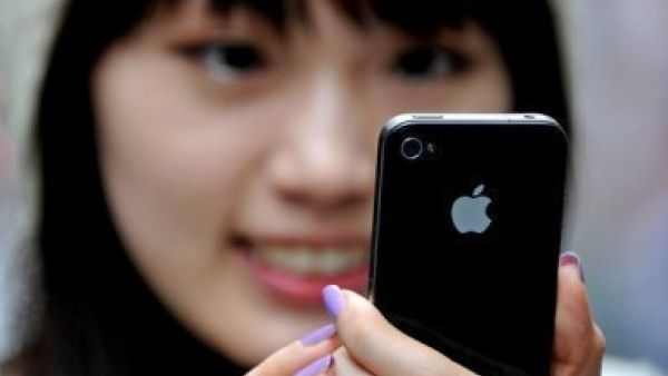 A Chinese woman looks at her iPhone.