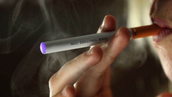 A woman smokes an e-cigarette (Getty image used for illustrative purposes)